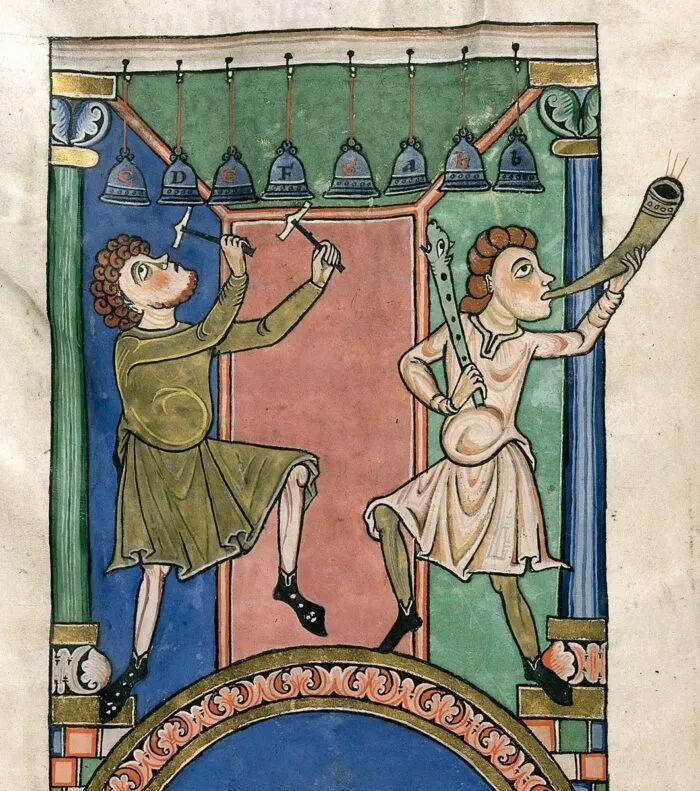 Eine illustrierte Folioausgabe aus der Wormser Bibel (1025–1075 n. Chr.) zeigt zwei Musiker mit mittelalterlichen Musikinstrumenten. Der Musiker links spielt Glockenspiel, der andere bläst ein Horn und hält ein Zink mit einem geschnitzten Tierkopf. Foto: unbekannter Künstler, Deutschland, 11. Jahrhundert n. Chr. Chr. (Lebenszeit: 11.-12. Jahrhundert n. Chr.), gemeinfrei