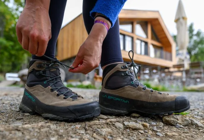 Eine Frau schnürt ihre Wanderschuhe. Deutschland gilt mit seinen vielfältigen Landschaften und Regionen als Wanderland.
