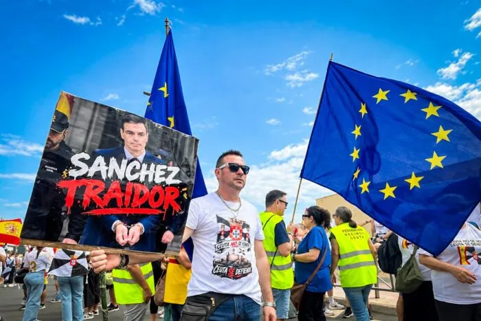 Ein Demonstrant fordert bei einem Protest von über 1.000 Einwohnern an der Grenze bei Tarajal die Ausweisung von Migranten und kritisiert Ministerpräsident Pedro Sánchez als „Verräter“.